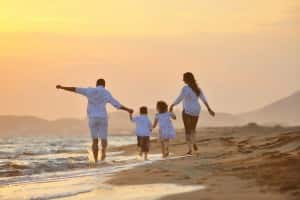 happy-young-family-have-fun-on-beach-at-sunset